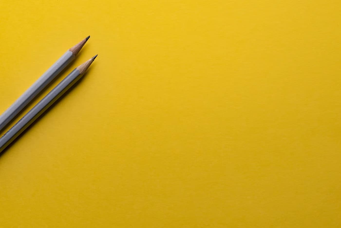 two pencil with yellow background
